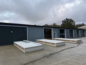 Three 6m x 2.3m XPandaOffices in off white, flatpacked and ready to install for the National Slate Museum