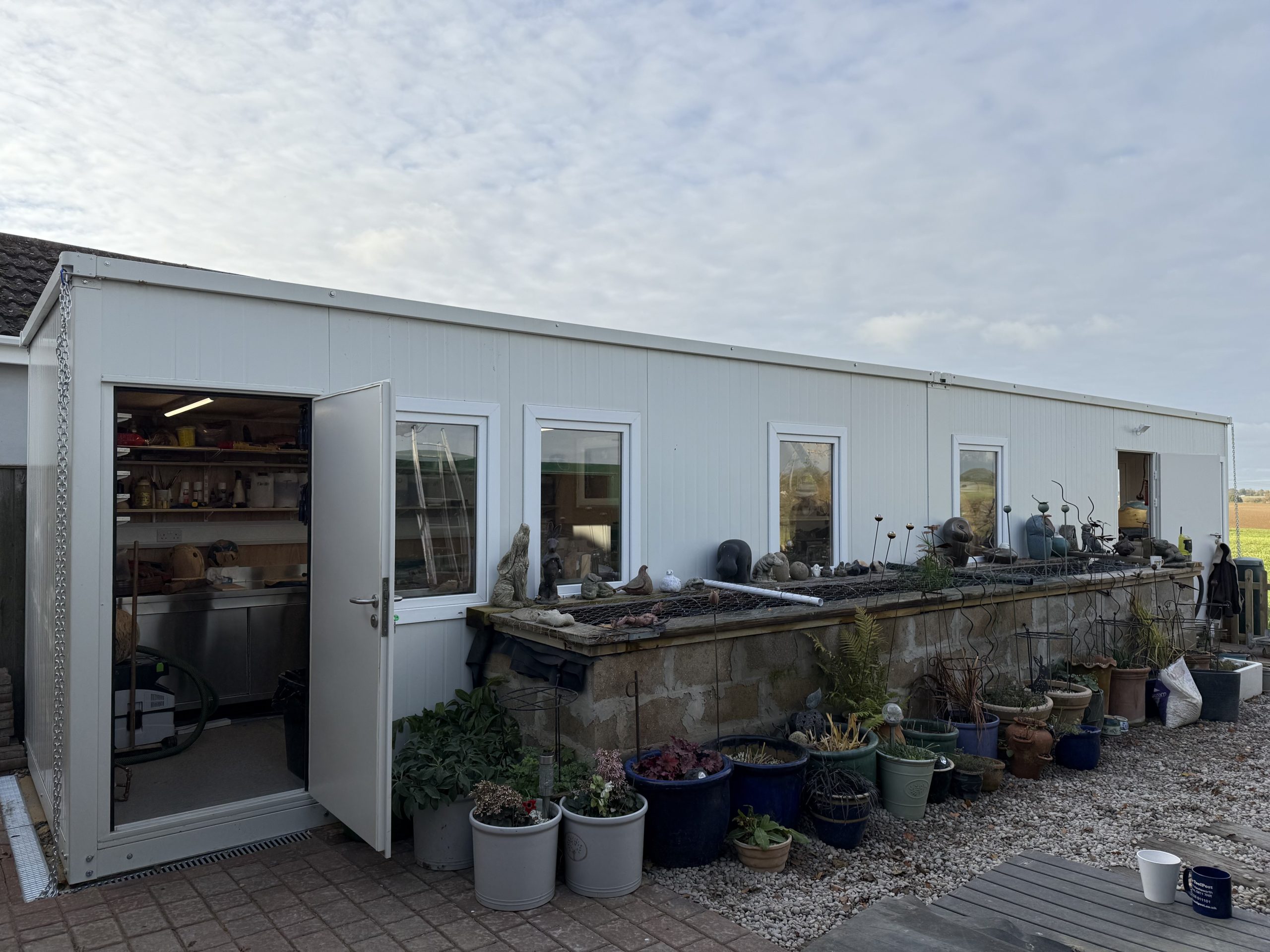 Exterior of two linked XPandaOffice units forming the 12m woodworking and resin curing workshop